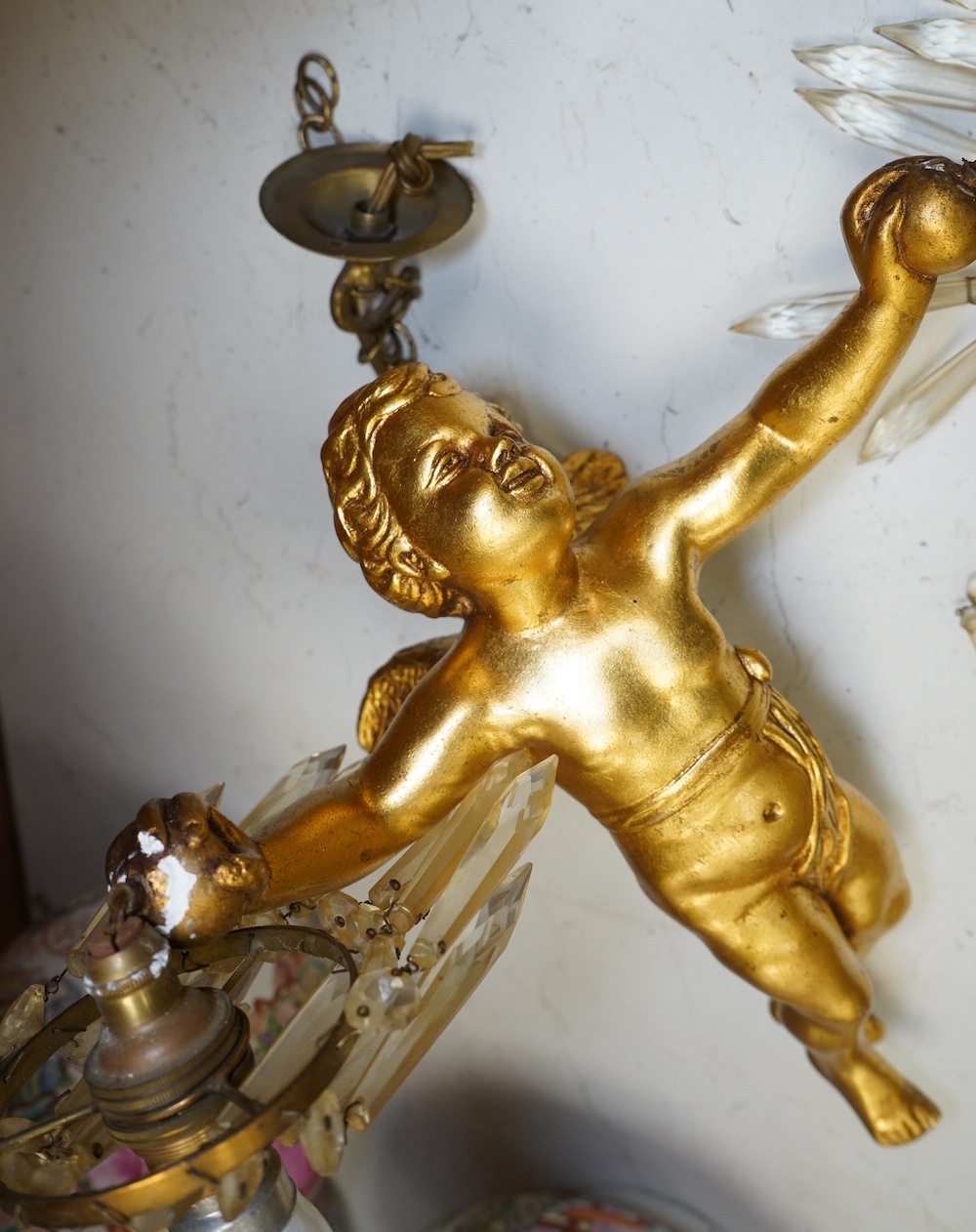 A gilt plaster hanging ‘cherub’ light fitting, 33cm long. Condition - fair